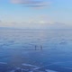 Aerial View of Two People Skating on a Large Frozen Lake. - VideoHive Item for Sale