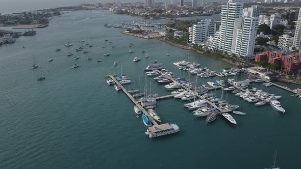 A moving shot of a cargo port in Cartagena, Colombia. Beautiful view of the bay with yachts and mode