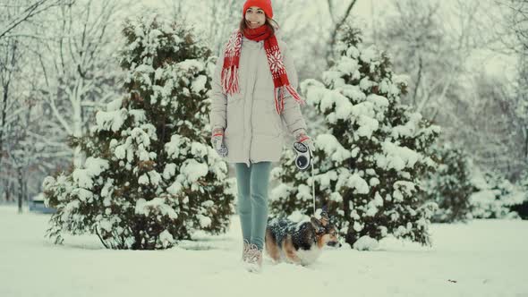 Slow Motion Portrait Beautiful Smiling Young Woman in Parka Knitted Red Beanie and Mittens Walks