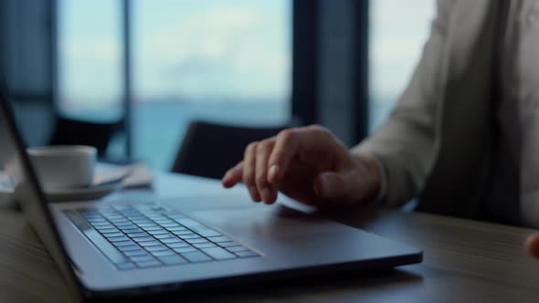 Businessman Hands Using Computer Touchpad in Ocean View Office