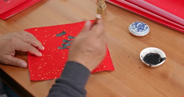 Man write chinese calligraphy for lunar new year