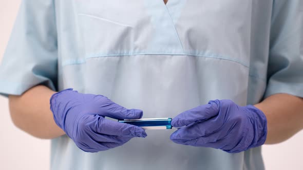 Epidemiologist Holds a Test for Coronavirus Covid 19. A Hand in Sterile Gloves.