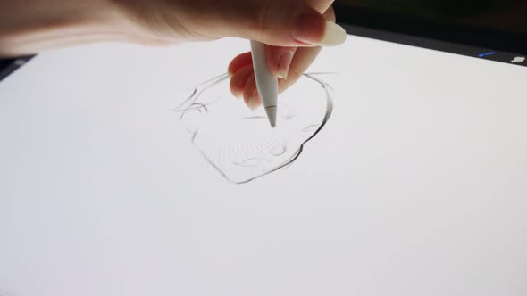 Close up of a digital pen drawing artwork on a graphic tablet