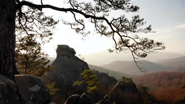 Aerial Flying over Rock Formation in the Middle of a Mountain Valley