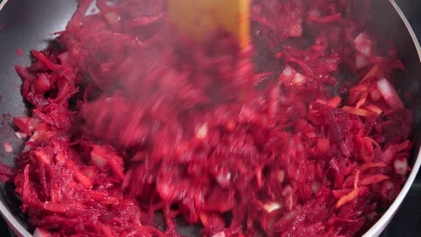 Cook Mixes Chopped Onion Grated Beetroot and Tomatoes in Pan