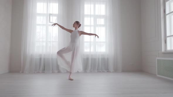 Graceful Girl Dancing Classical Ballet in a Bright Hall