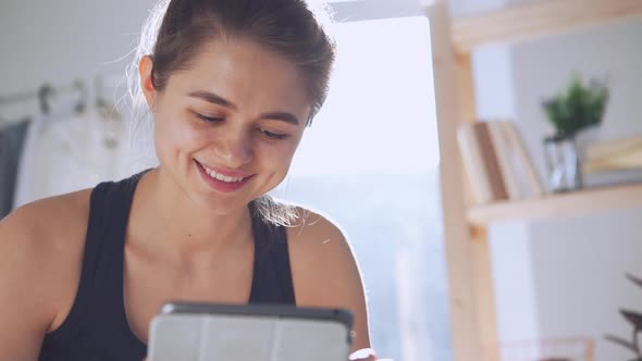 Young Caucasian Lady Using Tablet in Slowmotion