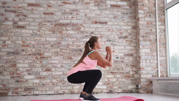 Young Woman Doing Active Situps to Strengthen the Feet in the Sports Center