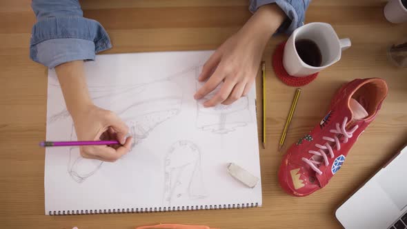 Woman Designer Working and Doing Sketch for Sneakers Top View