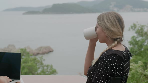 Close up pretty woman enjoying her coffee while sitting the table