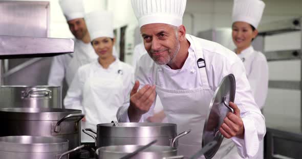 Head Chef Smelling Pot of Soup Making Ok Sign