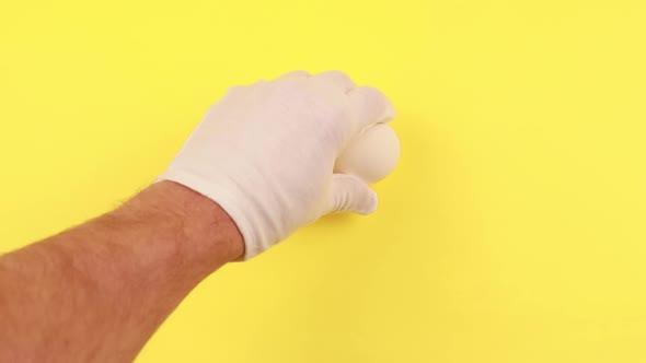 On a yellow background, four white chicken eggs