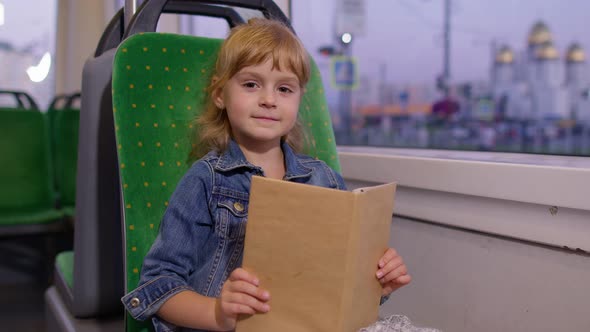 Portrait of Attractive Little Child Girl Kid Sitting at Empty Subway Train Reading Interesting Book