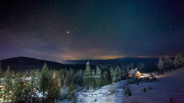 Snow Covered Mountain in Winter Sky View and Snowfall Sky Changing From Yellow Hues at Dawn to Blue