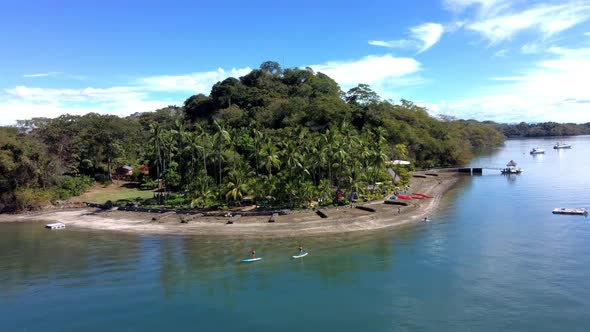 Beach in Costa Rica with surfers and tourist boats. Province of GuanacasteAerial drone shot in 4k p