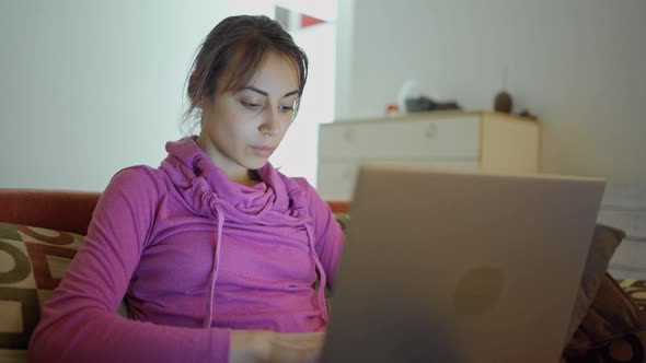 Thoughtful Concerned Woman Working on Laptop Computer at Home