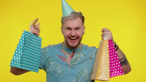 Tourist Man Showing Shopping Bags Advertising Discounts Low Prices Shopping on Black Friday Holiday