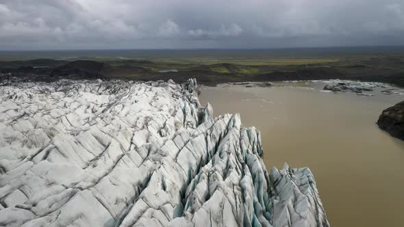 Glacier in Iceland with low view of drone video moving forward.