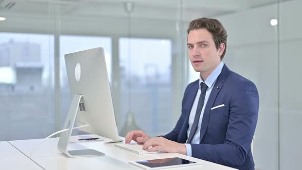 Serious Young Businessman Saying No with Finger Sign