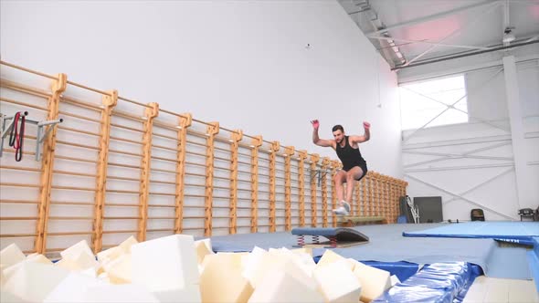 Sportsman Runs Up and Jumps on Trampoline Does Double Front Flip