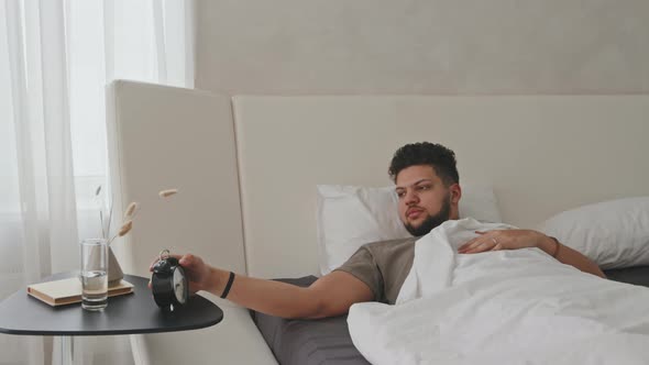 Young Latin Man Awakening In Bed At Home