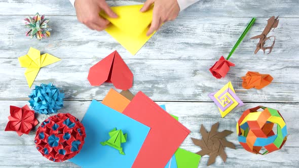 Man Bend Paper To Make Origami.