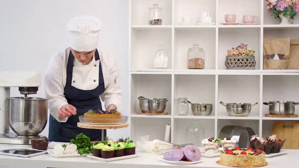 Confectionery Lady Adding Sweet Decor to Amazing Pastry on Plate