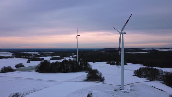 Aerial view of a wind farm in winter. Aerial view of rotating wind turbines.