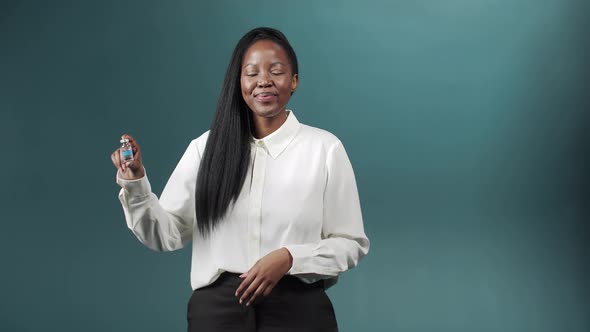 A Cute Young African Lady is Keeping One Ampule of Vaccine Against Coronavirus and Showing a Thumb