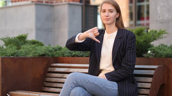 Thumbs Down by Upset Business Woman Looking at Camera