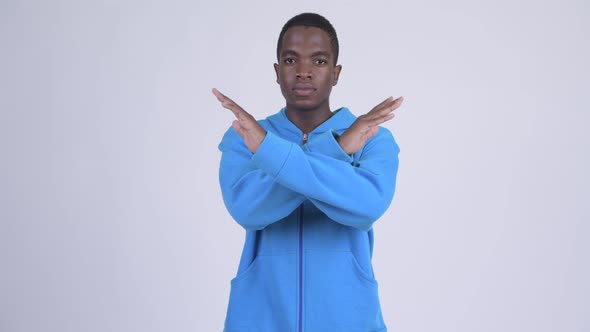 Young Serious African Man with Stop Gesture Using Arms