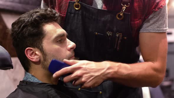 Man getting his beard trimmed with trimmer