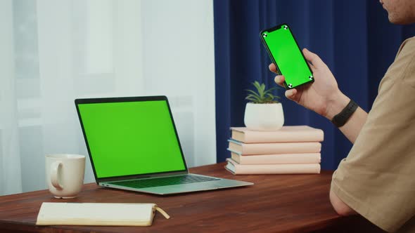 Man Student Using Smartphone and Laptop with Chroma Key Closeup