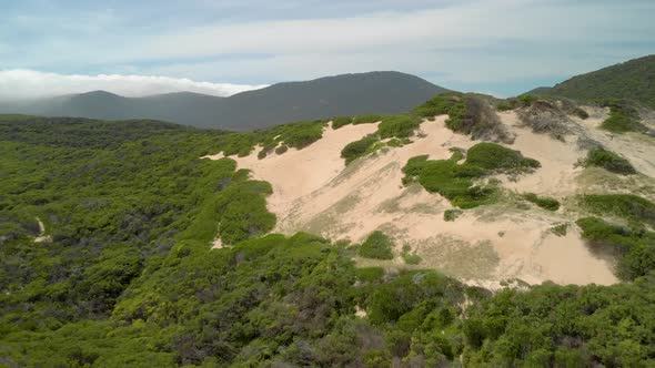 Aerial shot of sand-dunes and big mountains in Victoria Australia.