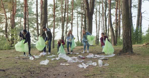 Team of Adults and Kids in Protective Gloves Collecting Rubbish in the Park