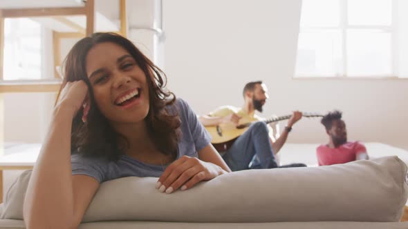 Beautiful woman smiling while sitting on the couch