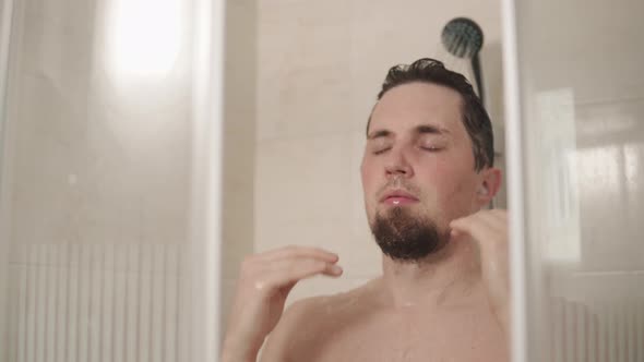 Man Preparing for the Day in Shower.