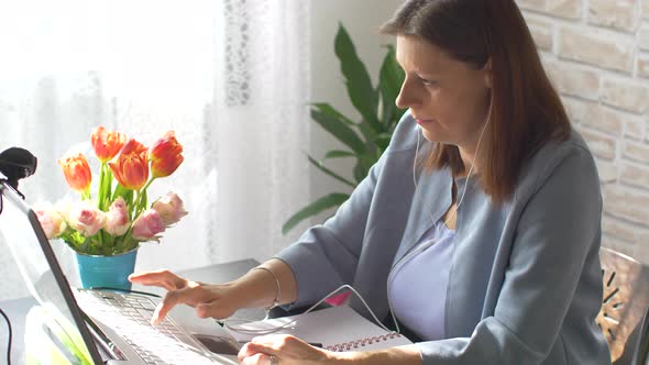 Young woman is bored at home working on pc