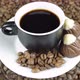 Chocolate Candies And A Cup Of Black Coffee On A Background Of Rotating Coffee Beans Top View. - VideoHive Item for Sale