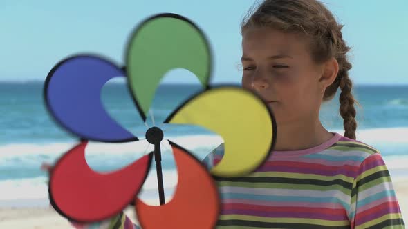 MCU OF A GIRL SPINNING A PIN WHEEL