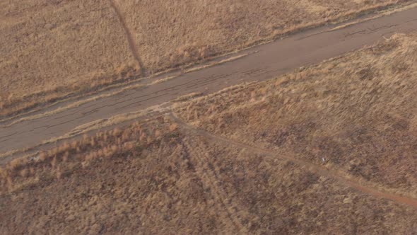 AERIAL shot showing ground surface of an old abandoned race track