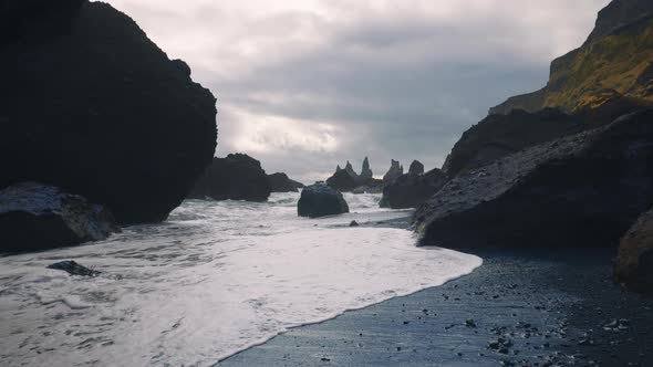 Cliffs and Waves Crashing to the Shore on Black Sand Beach