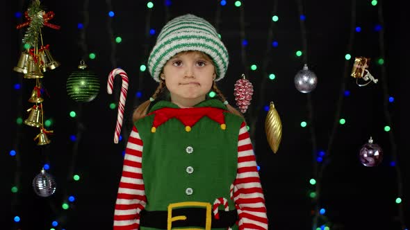 Shy Shamed Child Girl Christmas Elf Santa Helper Costume Posing Looking Camera Making Funny Faces