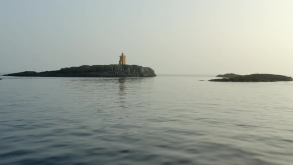 Flying Towards Orange Lighthouse Near Flatey Island, Iceland. Aerial Drone