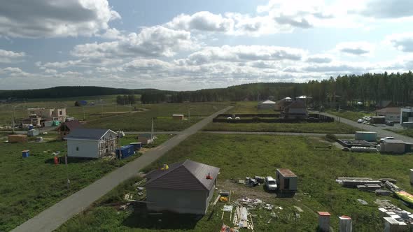 Construction houses in new cottage village. Aerial 34