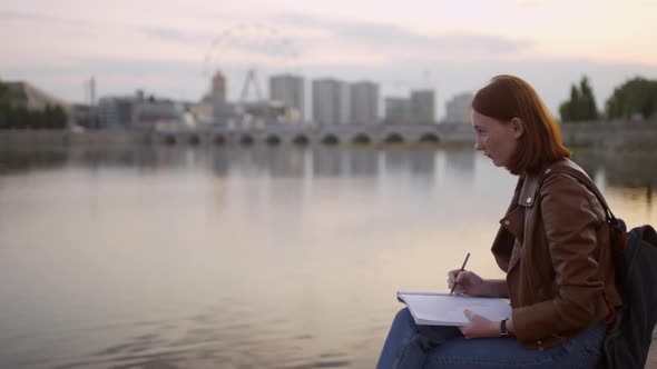 Creative Art Student Sketching Cityscape at Sunset