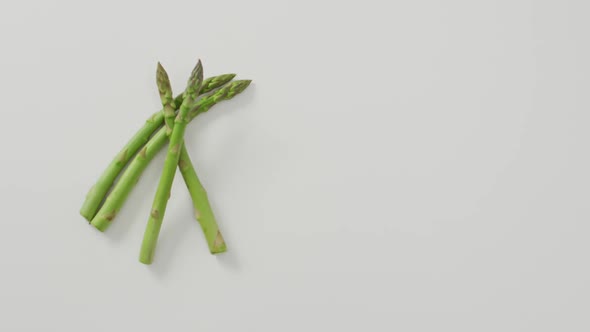 Video of fresh asparagus with copy space over white background