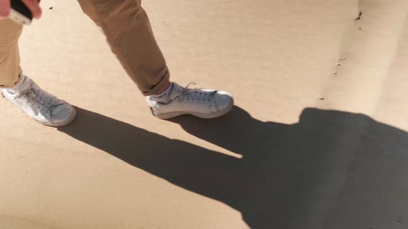 Closeup of Feet Walking in the Sand