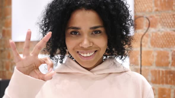 AfroAmerican Woman Gesturing Okay Sign Indoor