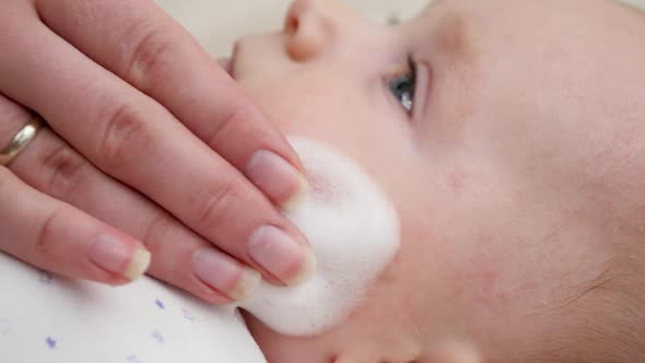 CLoseup of Mother Applying Medical Ointment for Curing Baby Dermatitis and Acne